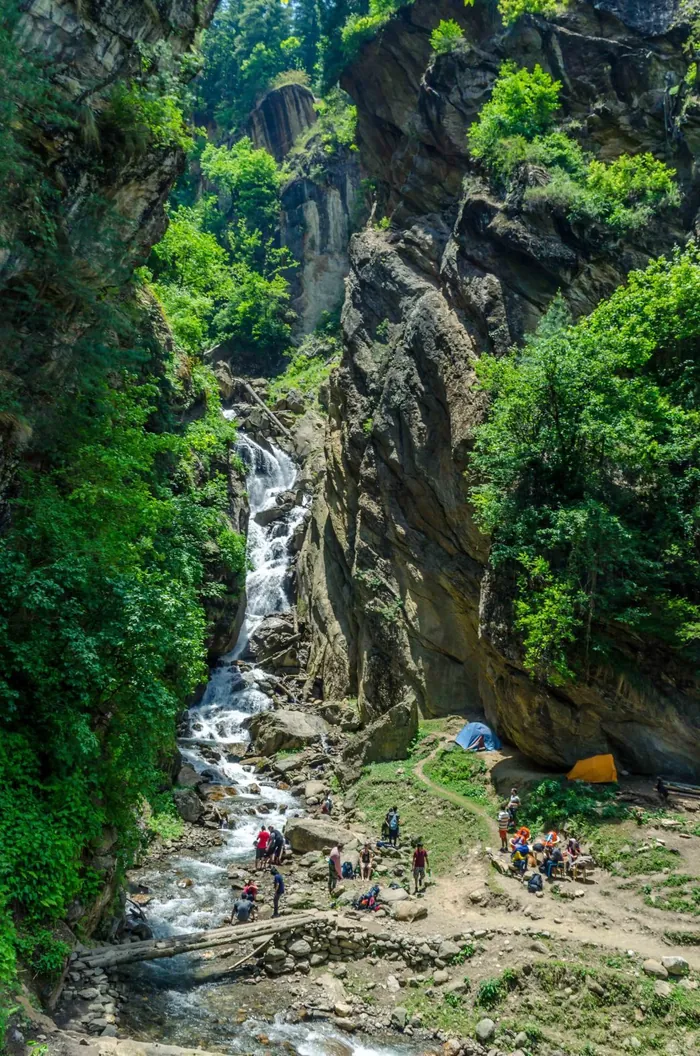 Waterfall in a forested mountain gorge