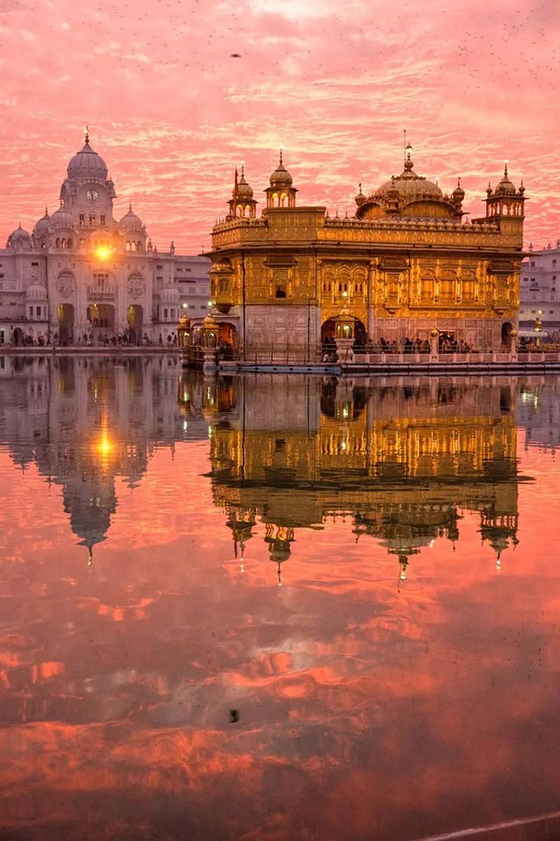 The Golden Temple glowing at sunset, reflected in the sacred pool, Amritsar